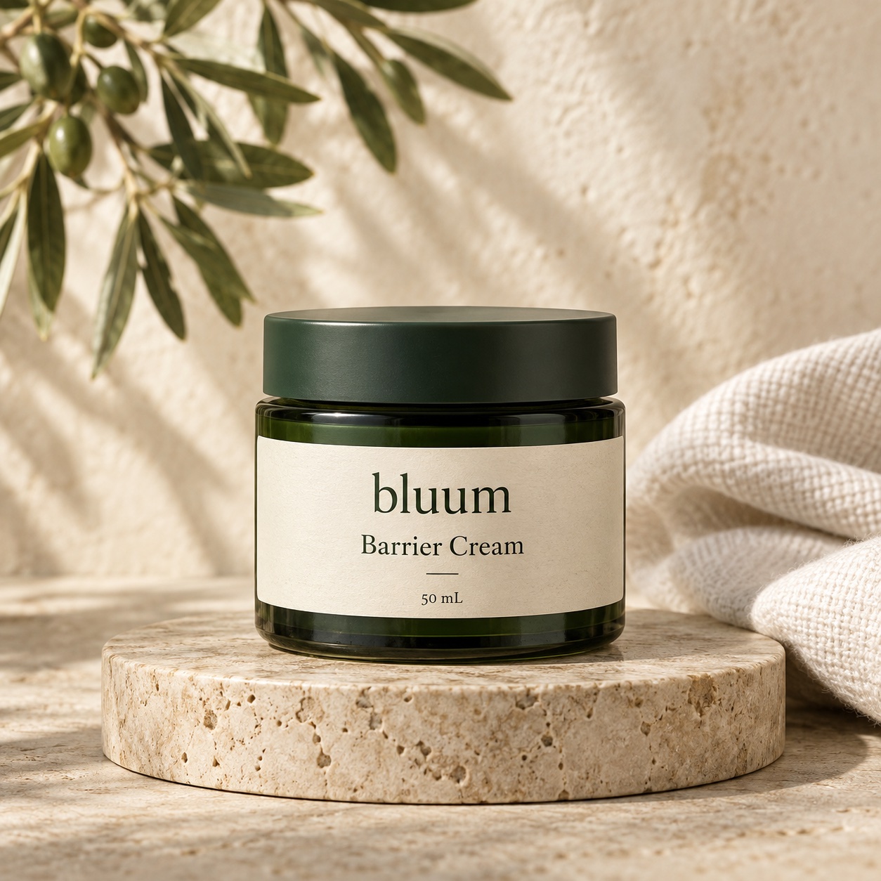 Bluum Barrier Cream in a forest-green jar on a stone ledge